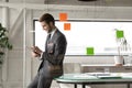 Smiling young businessman using digital computer tablet in office. Royalty Free Stock Photo