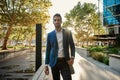 Smiling young businessman walking to work in the city Royalty Free Stock Photo