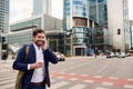 Smiling businessman walking to work on his morning commute Royalty Free Stock Photo