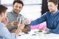 Smiling young businessmen drinking water and discussing new project Royalty Free Stock Photo