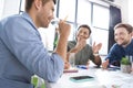 Smiling young businessmen drinking water and discussing new project Royalty Free Stock Photo