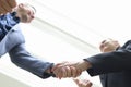 Smiling young businesspeople shaking hands in handshake Royalty Free Stock Photo