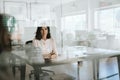 Smiling young businesswoman sitting inside of her office Royalty Free Stock Photo