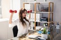 Businesswoman Exercising With Dumbbells