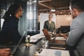 Smiling businesswoman giving a presentation to office coworkers Royalty Free Stock Photo