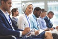 Smiling young businesswoman looking at camera during seminar Royalty Free Stock Photo