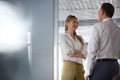 Smiling young businesswoman with male colleague in office Royalty Free Stock Photo