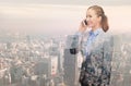 Smiling young businesswoman over city background Royalty Free Stock Photo