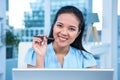 Smiling young businesswoman sitting at her desk Royalty Free Stock Photo