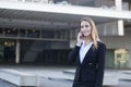 Smiling young businesswoman talking on mobile phone outdoors Royalty Free Stock Photo