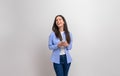 Smiling young businesswoman texting over smart phone and looking away on isolated white background Royalty Free Stock Photo