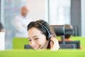 Smiling young businesswoman using headset in office Royalty Free Stock Photo