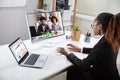 Happy Businesswoman Videoconferencing With Her Colleagues