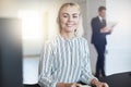 Smiling young businesswoman wearing a headset at her office desk Royalty Free Stock Photo