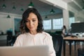 Smiling young businesswoman working on her laptop in an office Royalty Free Stock Photo