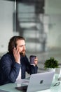 Smiling young call center man operator in headset working with laptop in office Royalty Free Stock Photo