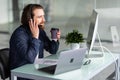 Smiling young call center man operator in headset working with laptop in office Royalty Free Stock Photo