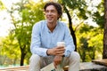 Smiling young casual man holding newspaper Royalty Free Stock Photo