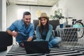 Smiling young Caucasian couple shopping online at home using a laptop with a credit card Royalty Free Stock Photo