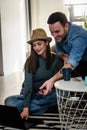 Smiling young Caucasian couple shopping online at home using a laptop with a credit card Royalty Free Stock Photo