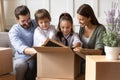 Happy family with kids unpack on relocation day