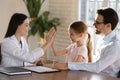 Happy female doctor cheer little child patient Royalty Free Stock Photo
