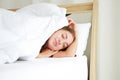 Smiling young Caucasian female sleeping and Having a good dream in the morning on a comfortable white bed and mattress in bedroom Royalty Free Stock Photo