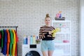 Smiling young Caucasian female Wearing yellow rubber gloves for clean of housework in loundry room. Lifestyle of Family on Holiday Royalty Free Stock Photo