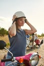 Smiling young caucasian girl putting on safety helmet Royalty Free Stock Photo