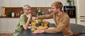 Smiling young caucasian homosexual pair sitting at table Royalty Free Stock Photo