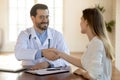 Male doctor handshake female client greeting at consultation