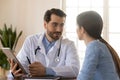 Young male doctor discuss results use tablet with patient Royalty Free Stock Photo