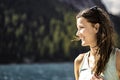 Smiling young caucasian woman with a beautiful view of Baires Lake in the Dolomite mountains, Italy Royalty Free Stock Photo