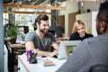 Smiling young colleagues sitting in office coworking. Royalty Free Stock Photo