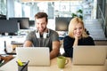Smiling young colleagues sitting in office coworking Royalty Free Stock Photo
