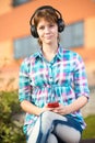 Smiling young college girl texting on a cell phone. Campus Royalty Free Stock Photo