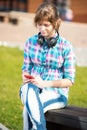 Smiling young college girl texting on a cell phone. Campus Royalty Free Stock Photo