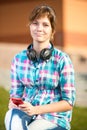 Smiling young college girl texting on a cell phone Royalty Free Stock Photo