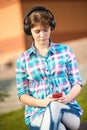 Smiling young college girl texting on a cell phone Royalty Free Stock Photo