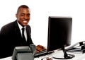 Smiling young corporate man using computer