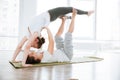 Smiling young couple doing acrobatic yoga position Royalty Free Stock Photo