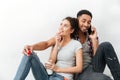 Smiling young couple drinking coffee and talking on cell phone Royalty Free Stock Photo