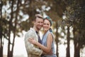 Smiling young couple embracing by olive tree at farm Royalty Free Stock Photo