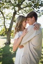 Smiling young couple embracing in park Royalty Free Stock Photo