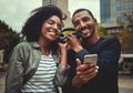 Smiling young couple enjoying listening to music on one headphone Royalty Free Stock Photo