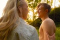 Smiling Young Couple Exploring Forest At Sunset