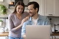 Smiling young couple have fun using laptop Royalty Free Stock Photo