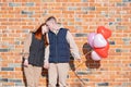 Smiling young couple holding hands standing in front of brick wall Royalty Free Stock Photo