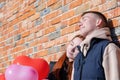 Smiling young couple holding hands standing in front of brick wall Royalty Free Stock Photo