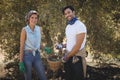 Smiling young couple holding olives in basket at farm Royalty Free Stock Photo
